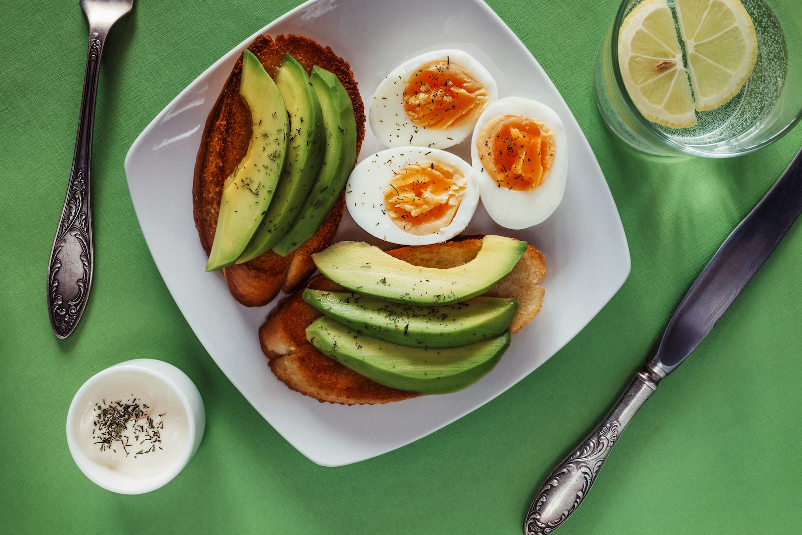 a white plate topped with eggs and avocado
